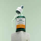 The Body Shop Vitamin C Glow Serum bottle sat on top of a stone block.