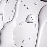 A close up shot of The Body Shop Tea Tree Oil texture on a grey background
