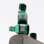 Two green bottles of The Body Shop Tea Tree oil on a white background