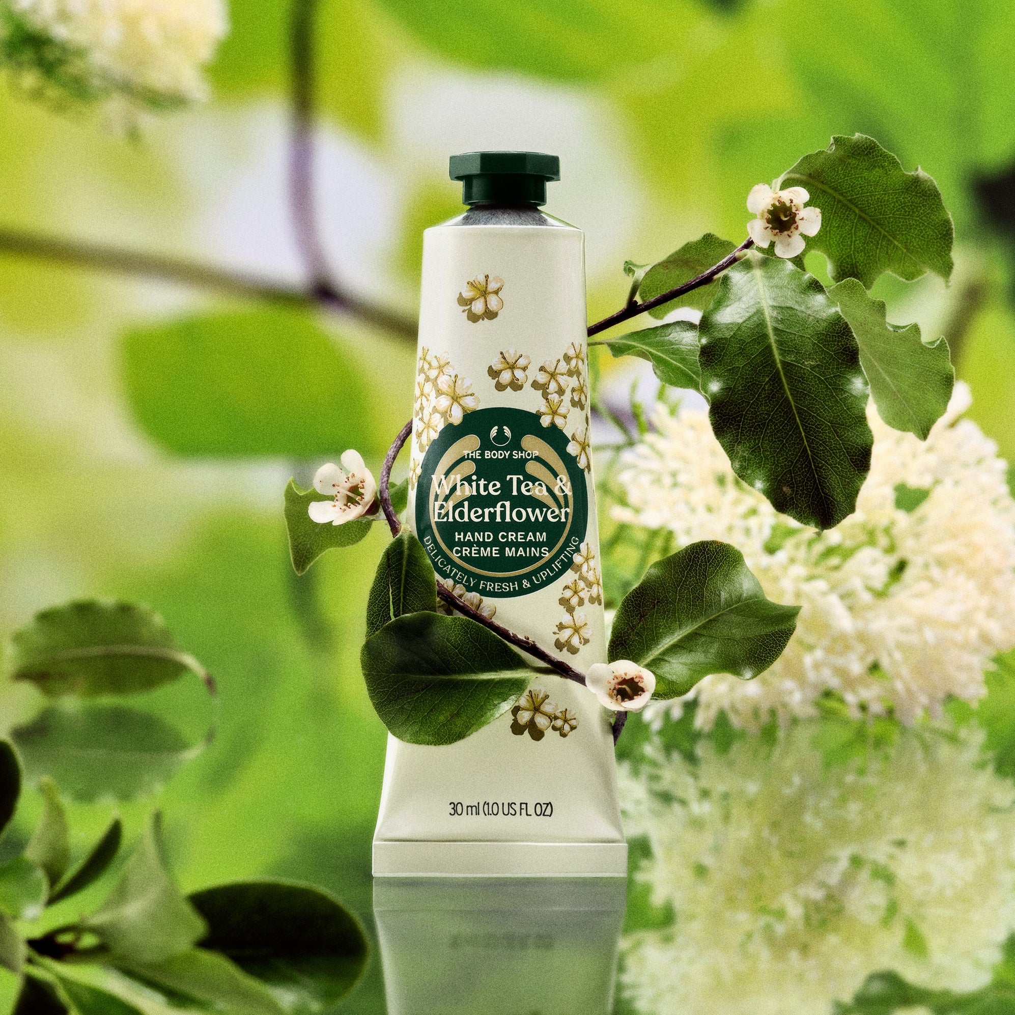 Hand cream tube with floral design against a natural background